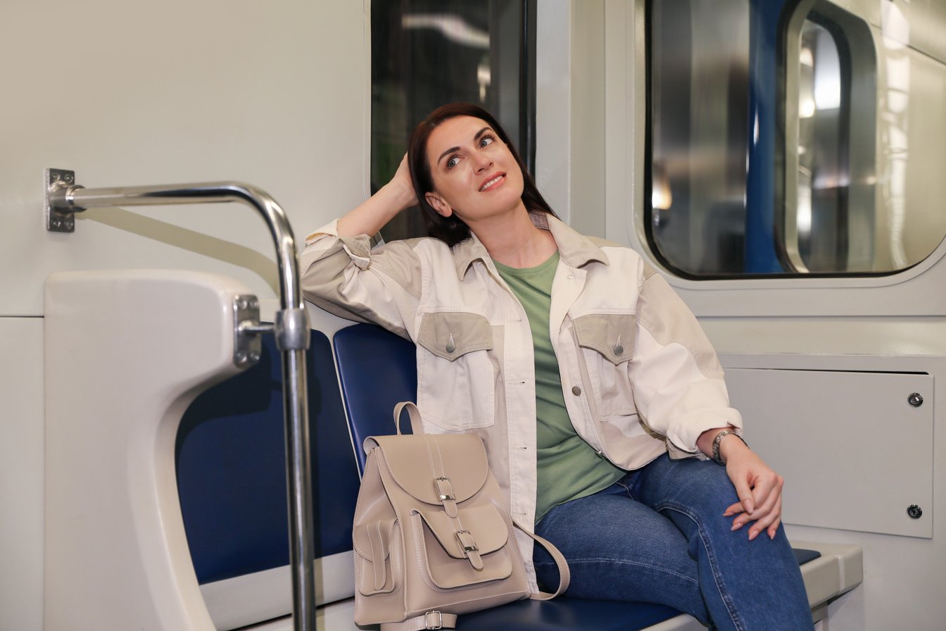 Beautiful Woman with Backpack in Subway Train. Public Transport